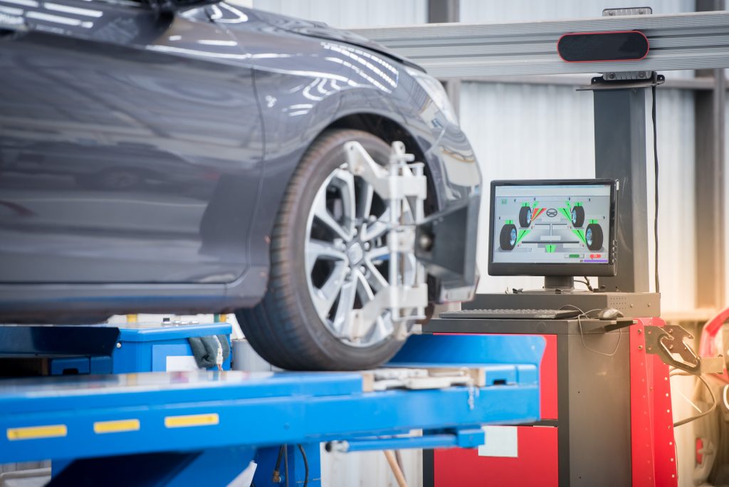 a photo of a mechanic performing a Wheel Alignment in Kenosha WI